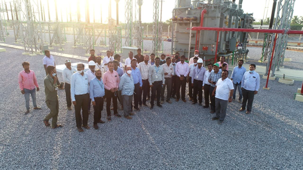 The team in the switchyard, a power transformer behind them